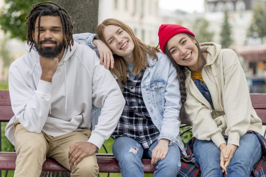 young-friends-outdoor-sitting-bench